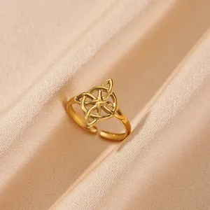 Detail shot of the 18K gold plated stainless steel open ring with chic geometric knot design.