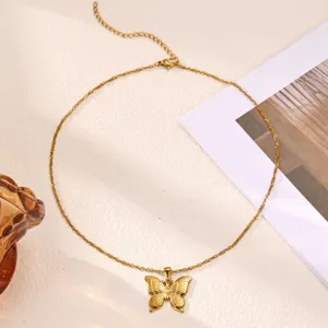 Close-up detail view of the elegant gold butterfly pendant necklace showcasing fine chain texture.