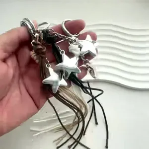 Braided leather star keychain bag charm, minimalist multi-strand lanyard accessory.
