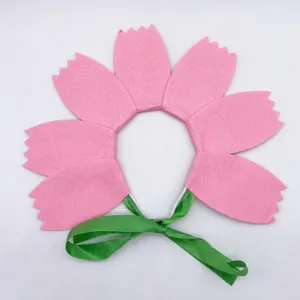 Pink felt flower headband with green ribbon detail, perfect for kids party or spring photo.