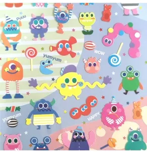 Cute cartoon monster stickers sheet with colorful candy designs for journal decoration.