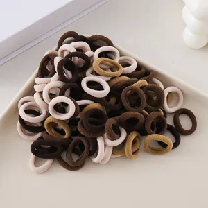 Seamless hair ties detail shot, elastic soft brown and beige rubber bands for daily hair styling.