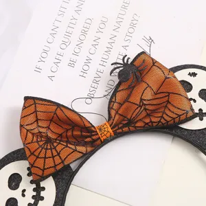 Halloween spiderweb bow headband detail featuring cute skull ears and spooky festival design.