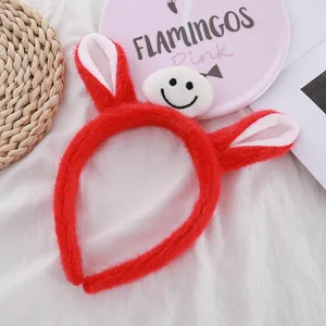 Joli serre-tête en peluche rouge avec visage souriant, accessoire de cheveux doux et mignon.
