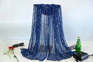 Detail view of a shimmering blue pleated chiffon sun protection scarf, elegant beach shawl accessory.