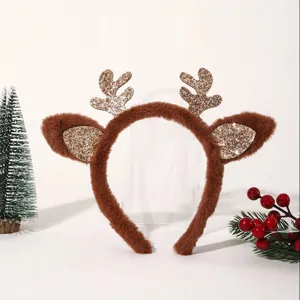 Close-up of Christmas reindeer antler headband, brown fuzzy texture, glitter ears.