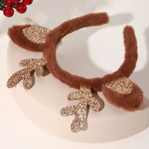 Close-up of brown plush Christmas reindeer antler headband with glitter details, holiday prop.