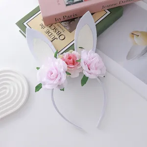 Detailed view of cute Easter bunny ear headband decorated with soft pink roses for kids party.
