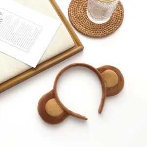 Detailed view of the cute plush monkey ear headband, soft fabric detail for autumn and winter.