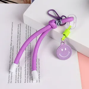 Colorful braided short lanyard keychain with smiley face pendant for phone case and bag decoration.