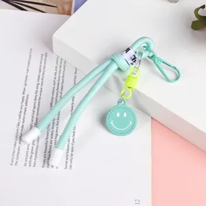 Mint green braided lanyard keychain with cute smiley face charm for phone cases and keys.