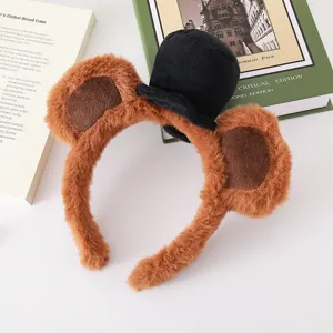 Close-up of plush bear ears headband with a mini black top hat for daily use and parties.