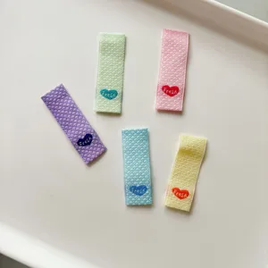 Etichette tessute piegate con ricamo a cuore e testo fresco per artigianato fai-da-te.