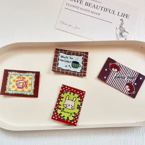 Detail view of retro cute embroidered cloth patches featuring cartoon bears, bunnies, and coffee cups.