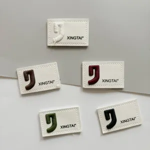 Embroidered leather labels details for garments, jeans, bags, and apparel accessories.