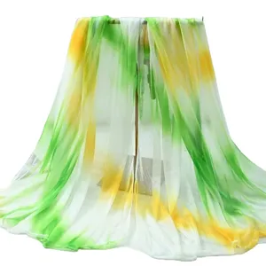 Details of the gradient chiffon scarf, showing lightweight fabric and tie-dye green yellow colors.
