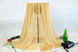 Detailed close-up shot of the shimmering gold pleated sequin scarf draped gracefully on a stand.