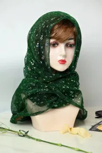 Detail view of the green metallic sequin pleated chiffon headscarf and sun protection shawl.