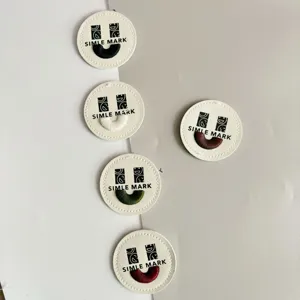 Round leather embroidered patches with cute smiley face design, perfect for clothing and bags.