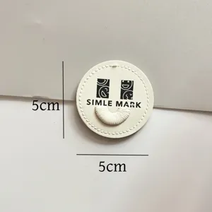 Round leather embroidered patch with smiley face design and size mark for clothing decoration.
