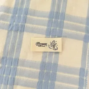 Cotton plaid fabric with handmade label, DIY sewing accessory for bags and clothes.