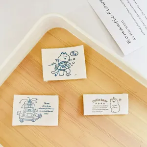 Cotton woven labels with cute cartoon cat bear designs, perfect for DIY sewing clothing decor.