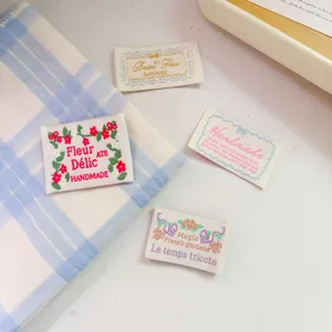 Close-up detail of vintage embroidered cloth labels, perfect for handmade DIY sewing.