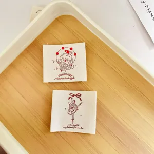 Detail shot of cute cotton clothing labels with printed designs for DIY sewing and garments.