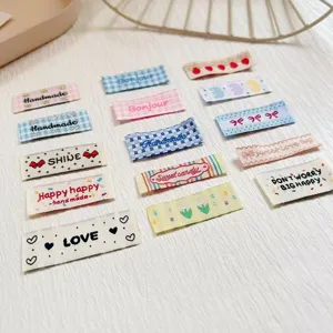 Detailed view of cute Korean-style embroidered fabric labels and DIY clothing accessory patches.