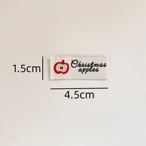 Custom woven clothing label with cute apple design and text for DIY sewing and apparel decoration.