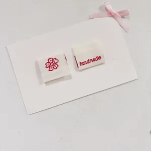 Handmade woven fabric labels with cute flower design, perfect for sewing bags, clothes and crafts.