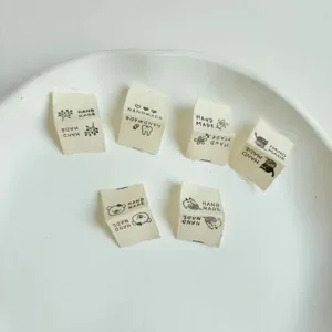 Handmade cotton clothing labels DIY sewing tags with cute animal designs for garments.