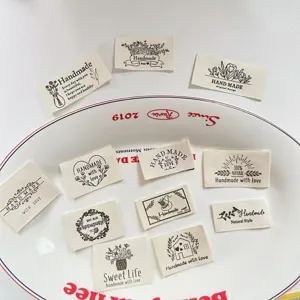 Handmade cloth labels for sewing and DIY crafts, featuring various botanical and cute designs.