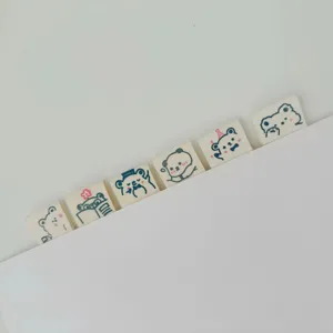 Close-up detail of cute cartoon bear cotton ribbon clothing labels for sewing crafts.