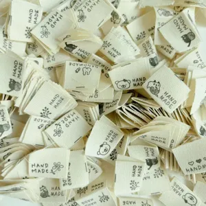 Detail view of cotton handmade labels with cute animal motifs for DIY craft accessories.