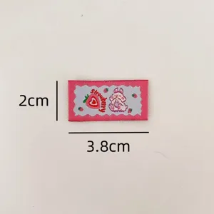 Close-up detail of cute rabbit strawberry woven label, perfect for DIY crafts and clothing.