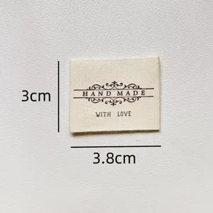 Handmade cotton fabric label with sewing decorative text and dimensions for DIY crafts.