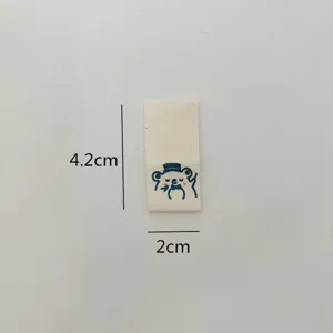 Handmade folded fabric label with cute bear design, perfect for hats, scarves, and clothing.