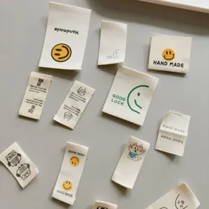 Cotton handmade woven labels with cute smiley and cat designs for DIY clothing accessories.