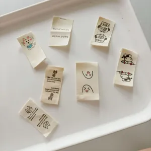 Cotton handmade printed labels, folding side labels featuring cute cat and smile face designs.