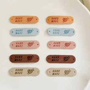 Handmade PU leather labels with holes, colorful DIY sewing tags for handmade crafts.