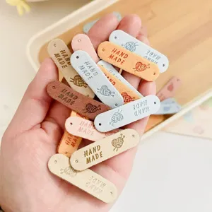 Colorful handmade faux leather labels with holes and text for DIY sewing craft accessories