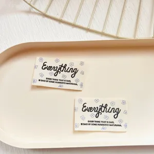 Cotton fabric labels with cute floral print and English text, perfect for sewing garments.