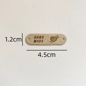 Handmade leather label detail view with 4.5x1.2cm dimensions for DIY sewing and crafting projects.