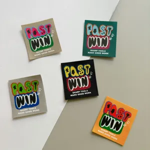 Close up detail view of assorted colorful woven patches, trendy graffiti style fabric labels.