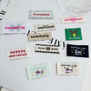 Detailed close-up of assorted cute puppy and holiday embroidered clothing labels for DIY sewing.