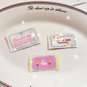 Embroidered fabric labels with colorful floral and cute rabbit motifs for DIY garments and bags.