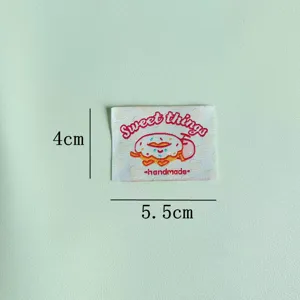 Close up detail of cute donut embroidery patch, handmade woven label for garment decor.