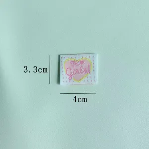 Handmade embroidered heart fabric patch, cute clothing accessory and sewing label for DIY crafts.