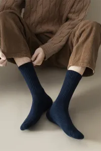 Close up detail of mens dark blue wool ribbed socks, cozy winter thermal comfort style.
